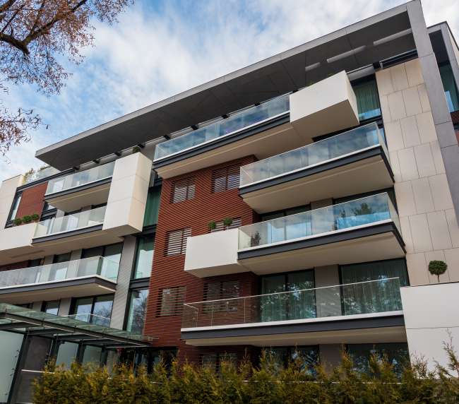 a building with balconies and trees