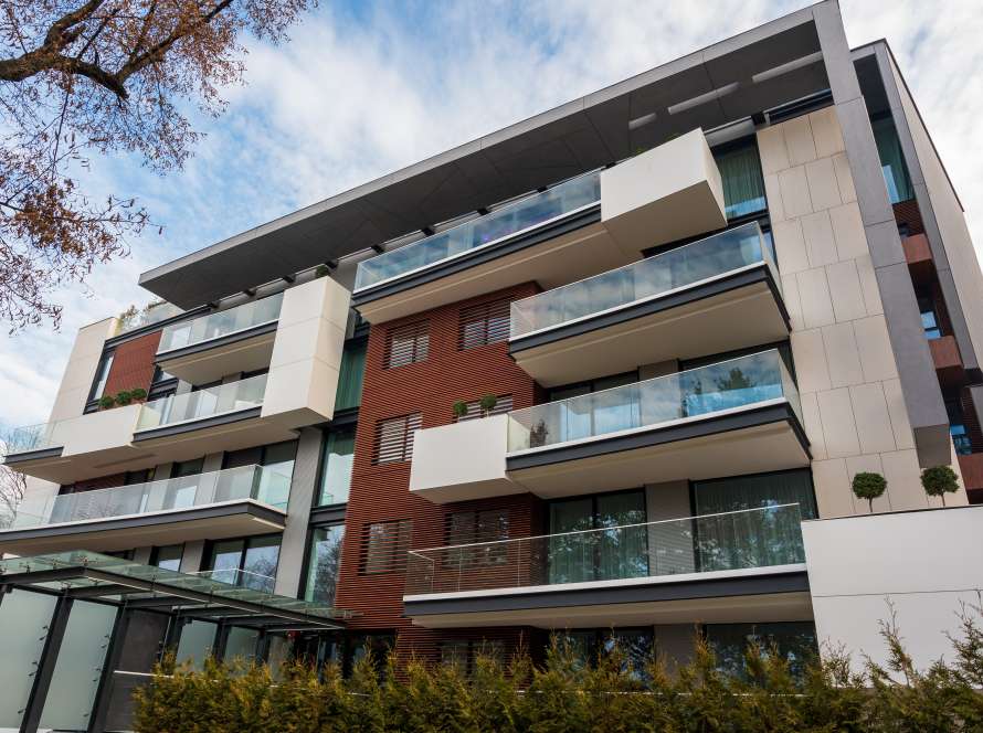 a building with balconies and trees